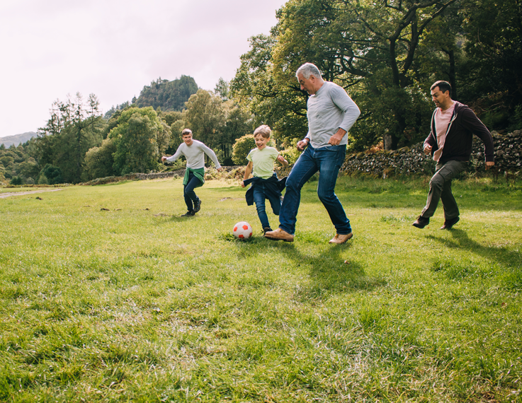active adult community amenities - playing soccer with grandad