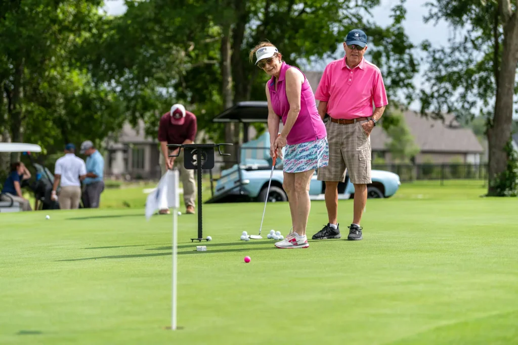 Residents enjoying the putting green at Chambers Creek, part of low-maintenance living near Conroe